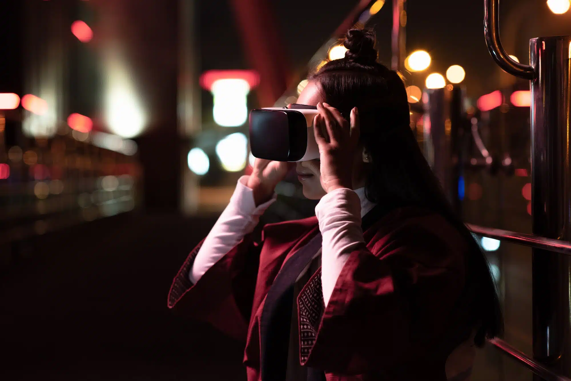 attractive asian girl using virtual reality headset on street in evening, city of future concept