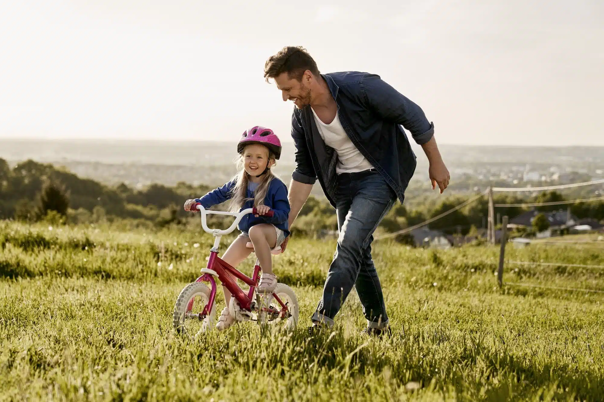 Caucasian man with toddler learning how to ride bike