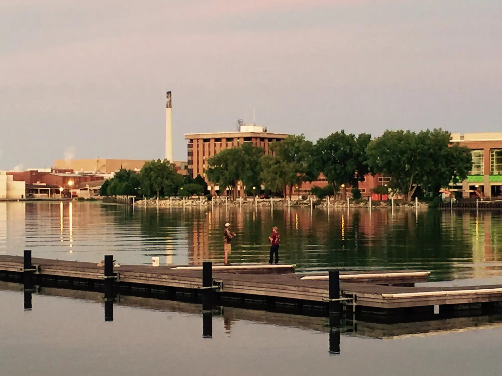 City fishing on the Fox River at dusk in Green Bay Wisconsin