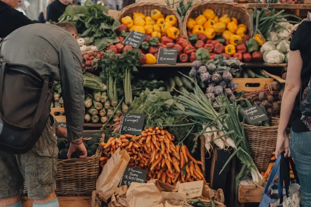 People buying vegetables at the farmers market