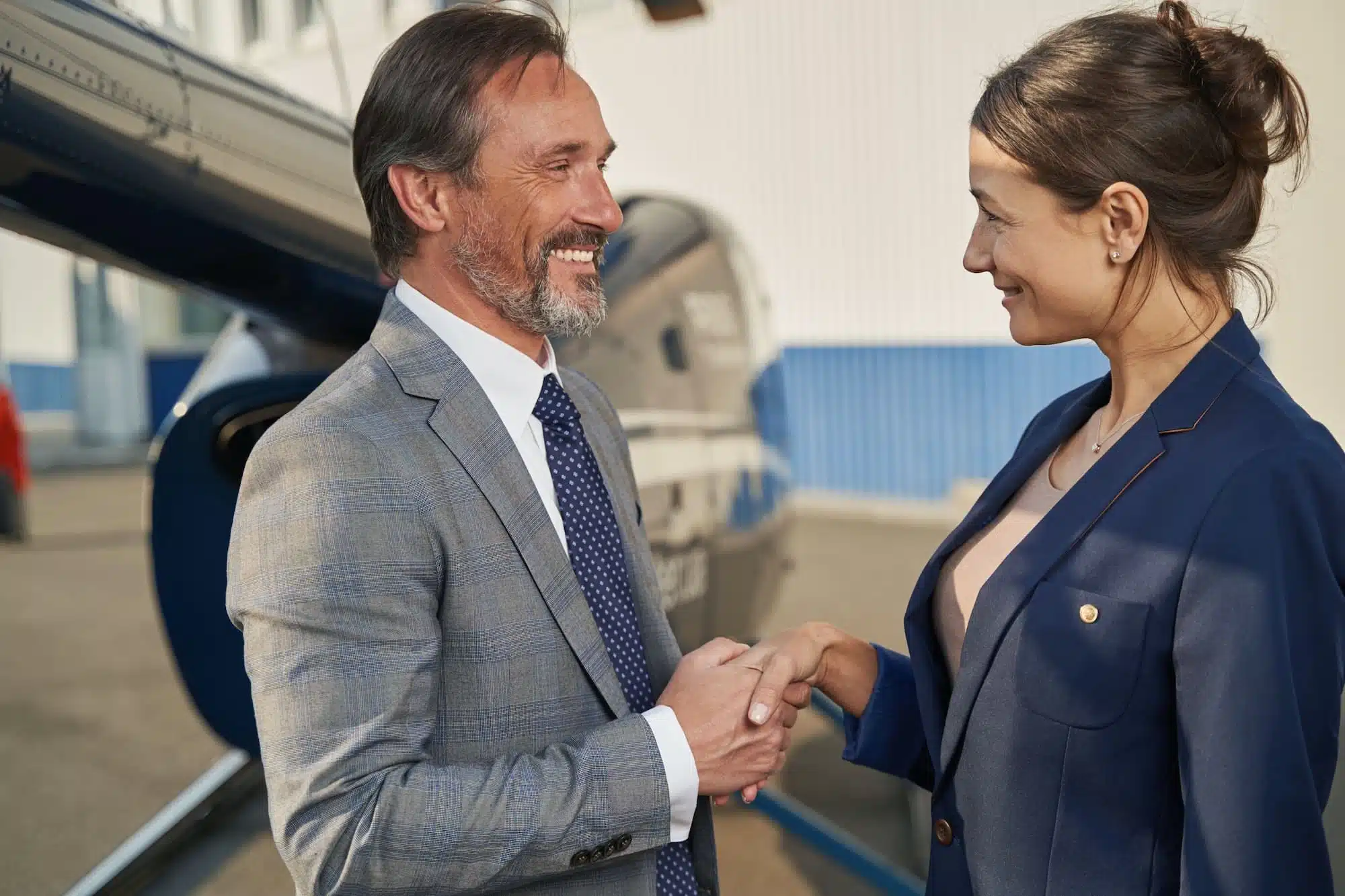Two businesspeople greeting each other at heliport