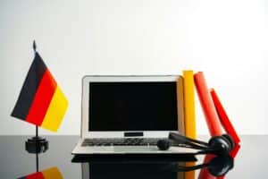 Laptop with German flag on working table, educational concept